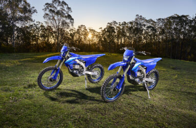 Two blue Yamaha MY27 WR450F positioned on grass.
