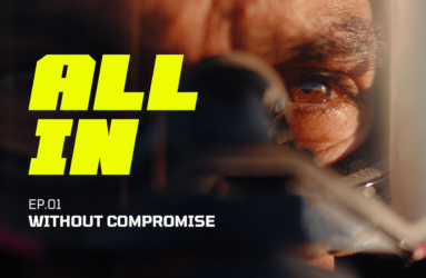 A man's face in a motorcycle helmet with bold yellow text 'all in'